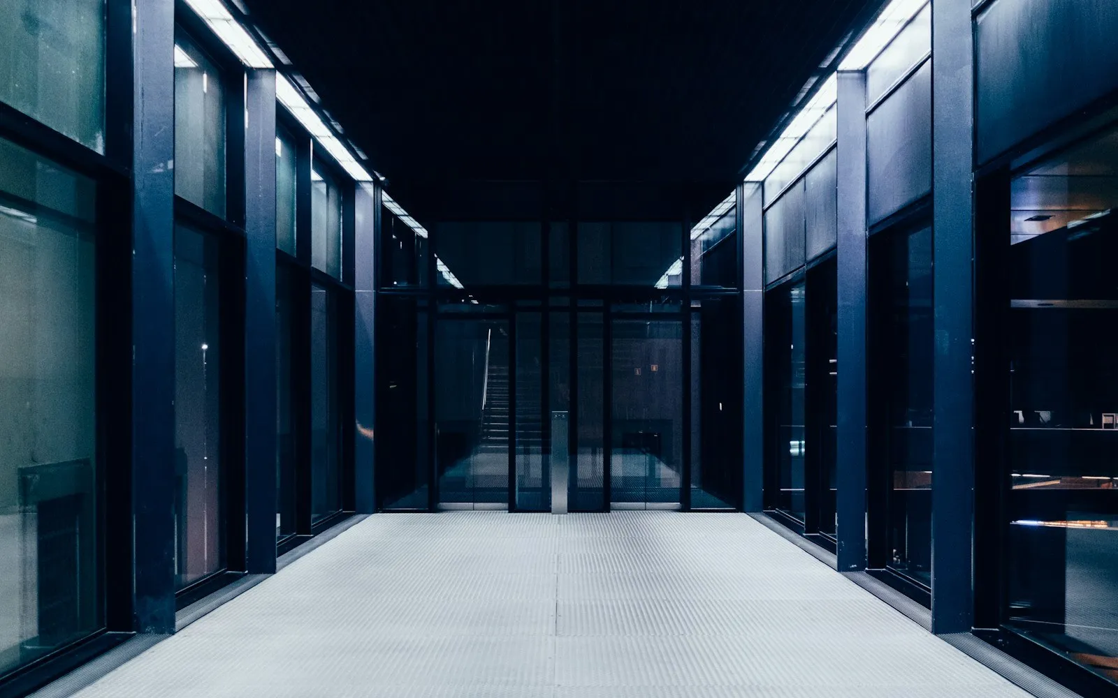 A dark data-hall aisle between rows of server cabinets