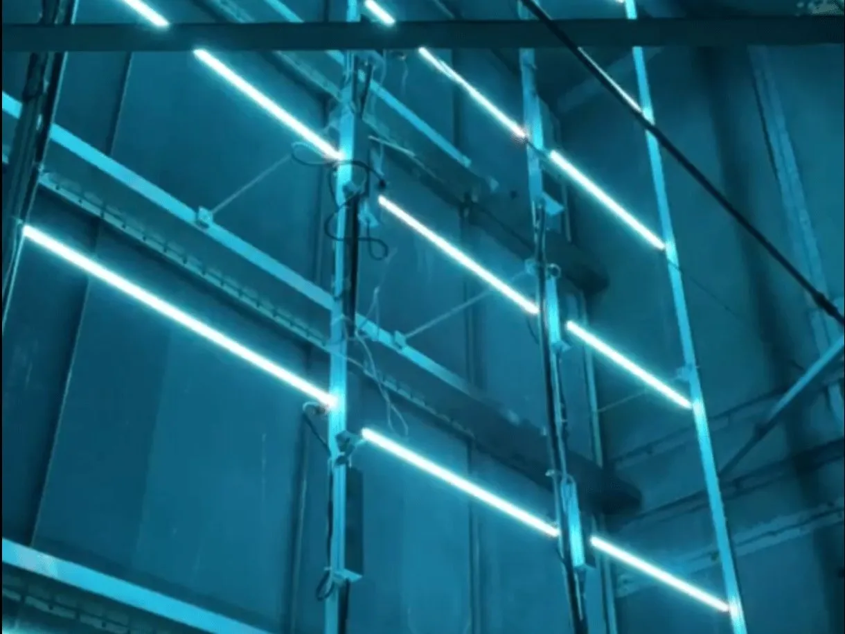 Cognituv Grid UV-C lamps lit across the coil of a large air handler