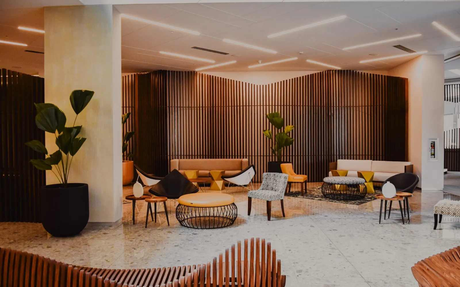A hotel lounge with warm lighting and seating